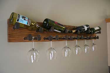 railroad spike as wall hook for bottles