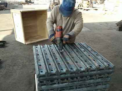 worker removes burrs in holes